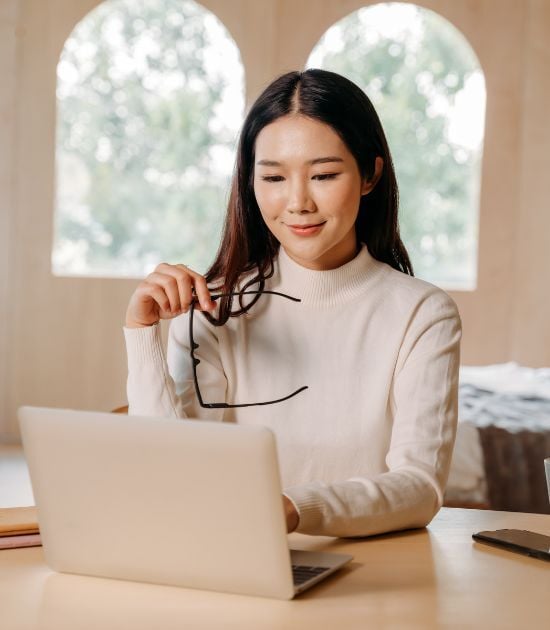 “Business professional reviewing pricing and licensing information on her laptop