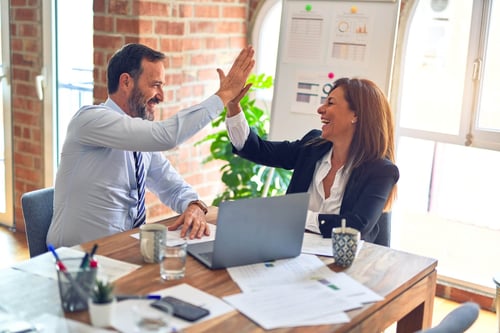 Two people giving high five for Sage Intacct