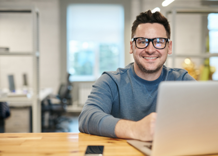 man smiling with laptop