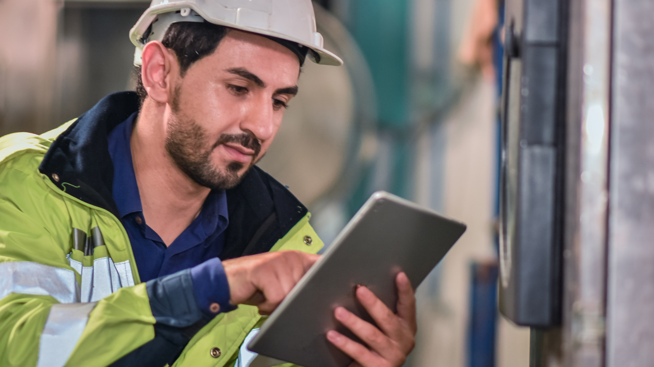 Male field service technician holding mobile tablet 