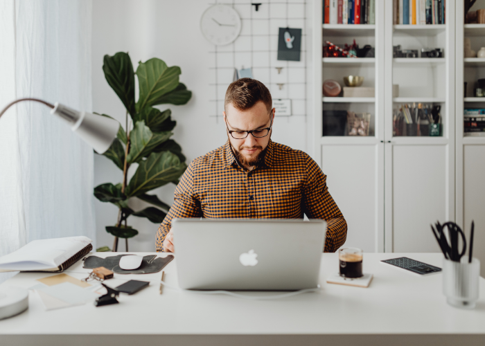 Man looking down to laptop screen. 