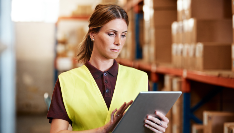 woman in factory looking at ipad
